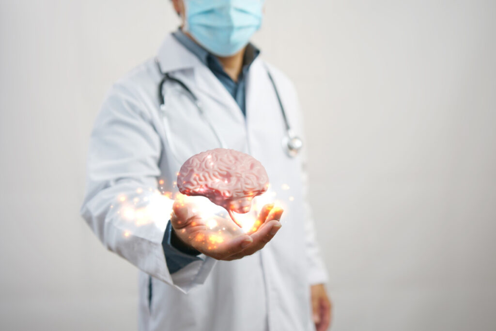 Wizualizacja mózgu nad dłonią neurologa. Stwardnienie rozsiane — kto na nie choruje